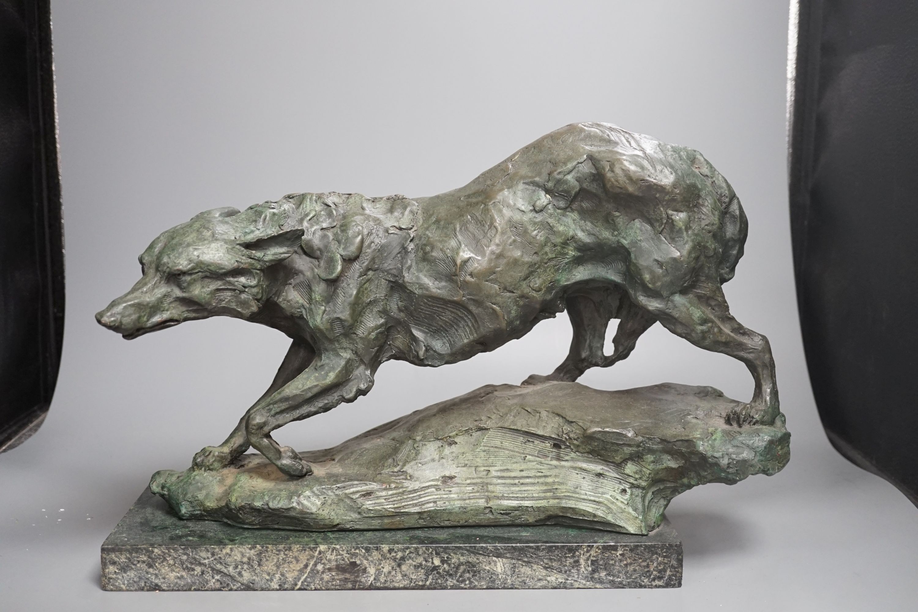 B.C. King, a green patinated bronze of a wolf, 43 cms wide.